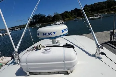 Slide: The Image of 2017 Regulator 31 boat with radar and life raft, docked in a scenic marina. - 15