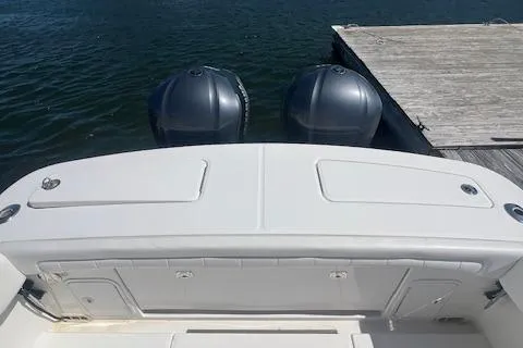 Slide: The Image of 2017 Regulator 31 boat with dual outboard motors docked by wooden pier. - 18