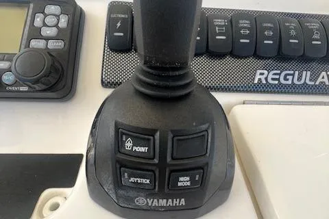 Slide: The Image of Yamaha joystick control on 2017 Regulator 31 boat dashboard with navigation buttons. - 9