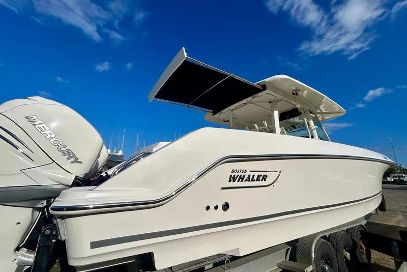 Slide: The Image of 2017 Boston Whaler 380 Outrage boat with Mercury engines under a clear blue sky. - 15
