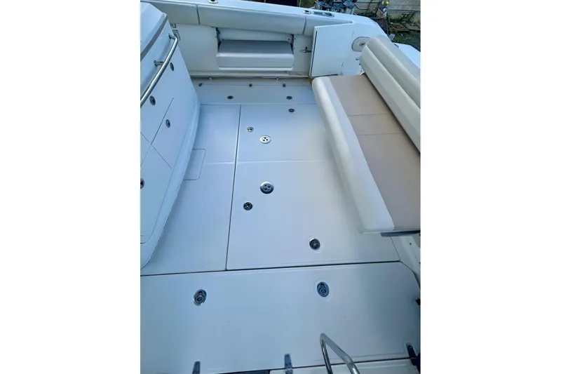 Slide: The Image of 2017 Boston Whaler 380 Outrage boat deck with seating and storage compartments. - 2