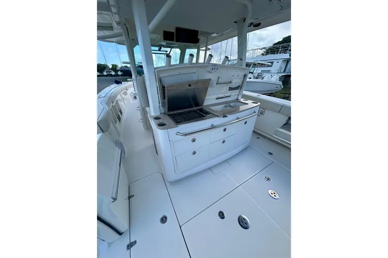 Slide: The Image of 2017 Boston Whaler 380 Outrage boat interior with sleek white deck and built-in amenities. - 4