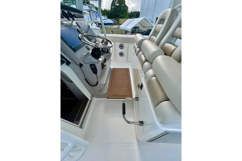 Slide: The Image of 2017 Boston Whaler 380 Outrage helm with steering wheel and cushioned seating. - 8