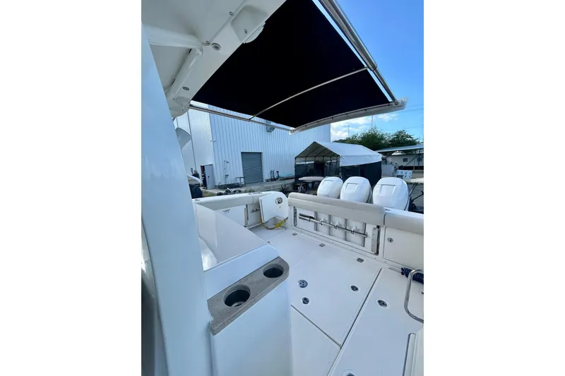 Slide: The Image of 2017 Boston Whaler 380 Outrage boat deck with seating and canopy. - 9