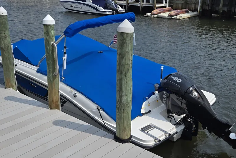 Slide: The Image of 2016 Sea Ray SPX 210 Outboard boat docked with blue cover and Mercury engine. - 6