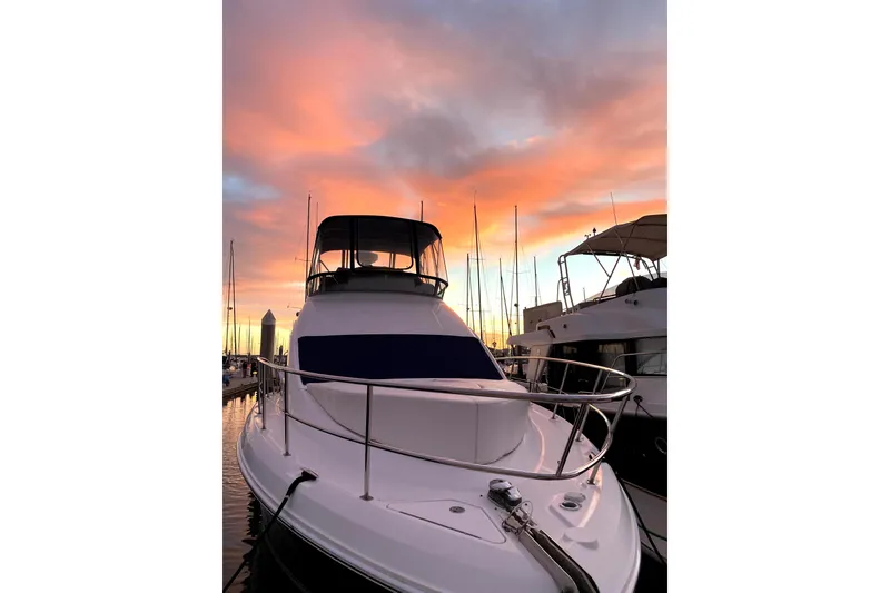 Slide: The Image of 2007 Sea Ray 36 Sedan Bridge yacht docked at sunset with vibrant sky. - 10