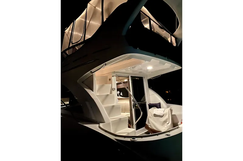 Slide: The Image of 2007 Sea Ray 36 Sedan Bridge yacht illuminated at night, showcasing elegant design and spacious interior. - 11