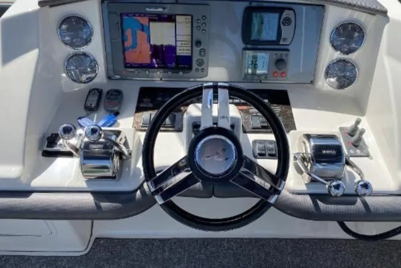 Slide: The Image of Helm of 2007 Sea Ray 36 Sedan Bridge with navigation controls and steering wheel. - 14