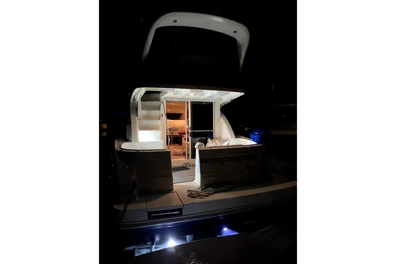 Slide: The Image of 2007 Sea Ray 36 Sedan Bridge yacht illuminated at night, showcasing its elegant design. - 17