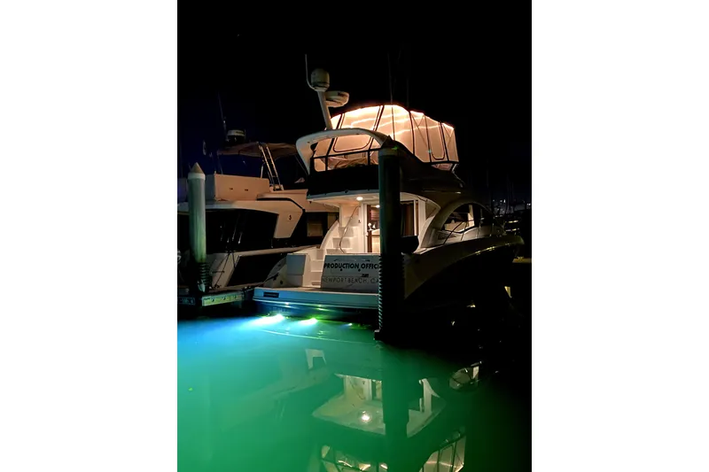 Slide: The Image of 2007 Sea Ray 36 Sedan Bridge yacht illuminated at night in marina. - 19