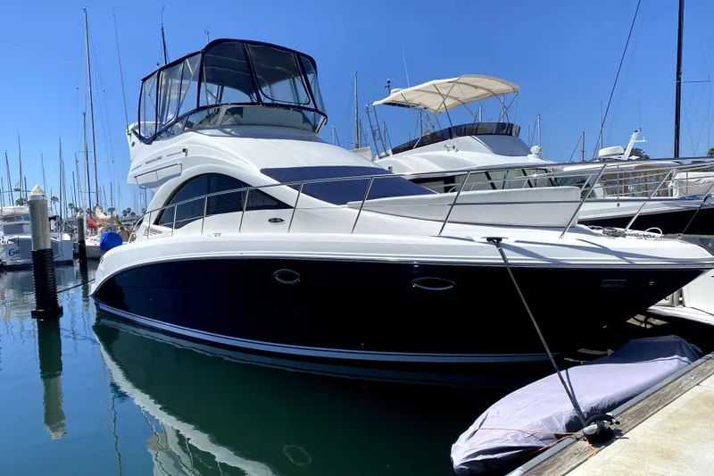 Slide: The Image of 2007 Sea Ray 36 Sedan Bridge yacht anchored near scenic coastline. - 3