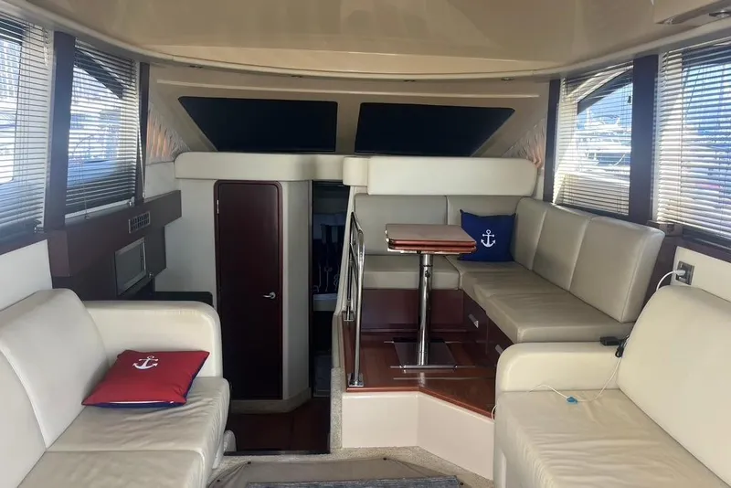 Slide: The Image of Interior of 2007 Sea Ray 36 Sedan Bridge with beige seating and nautical decor. - 30