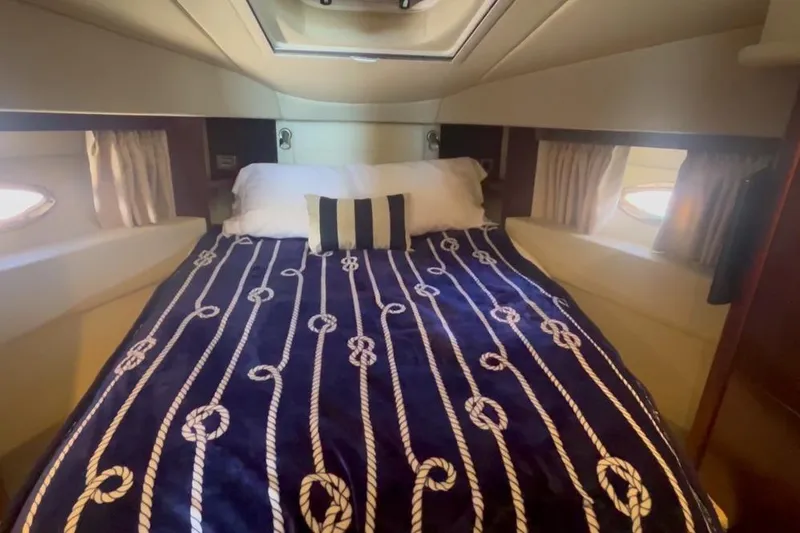 Slide: The Image of Cozy bedroom in 2007 Sea Ray 36 Sedan Bridge yacht with nautical-themed bedding. - 32