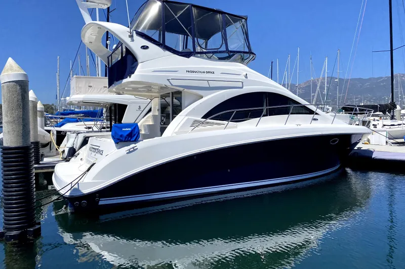 Slide: The Image of 2007 Sea Ray 36 Sedan Bridge yacht docked in marina, clear blue sky. - 4