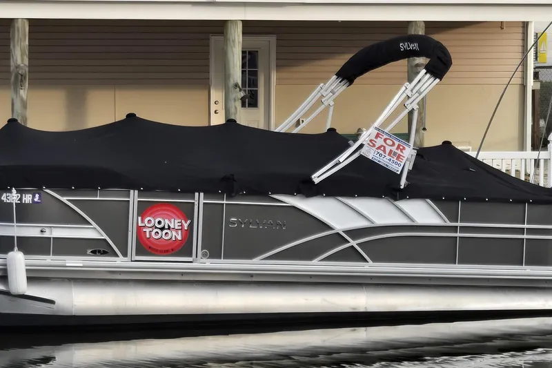 The Image of 2022 Sylvan L3 Party Fish pontoon boat with "For Sale" sign docked. - 0