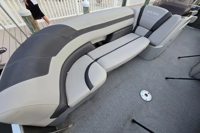 Slide: The Image of 2022 Sylvan L3 Party Fish boat interior with gray seating and carpeted floor. - 10