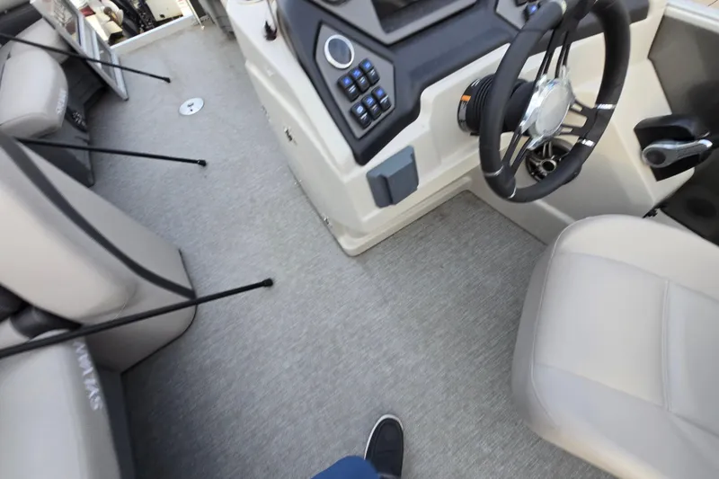 Slide: The Image of Interior view of 2022 Sylvan L3 Party Fish boat cockpit with steering wheel and seating. - 12