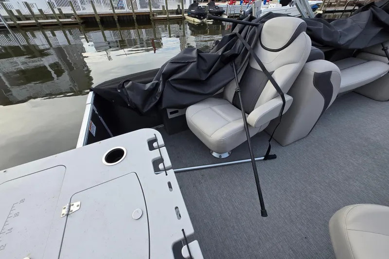 Slide: The Image of 2022 Sylvan L3 Party Fish boat interior with seating and covered equipment. - 14