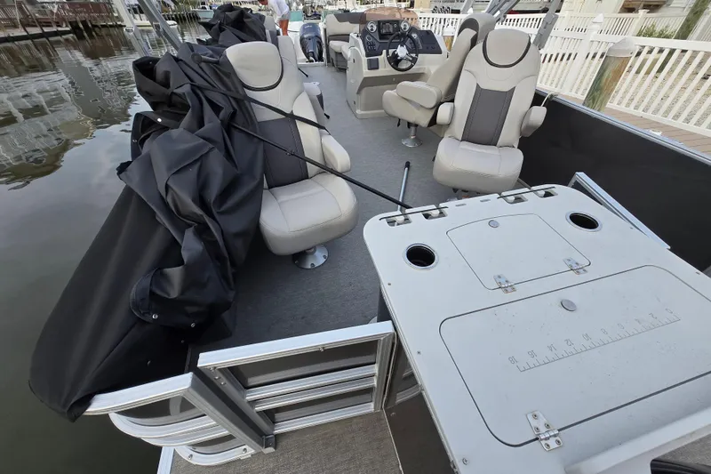 Slide: The Image of 2022 Sylvan L3 Party Fish pontoon boat interior with seating and fishing station. - 3