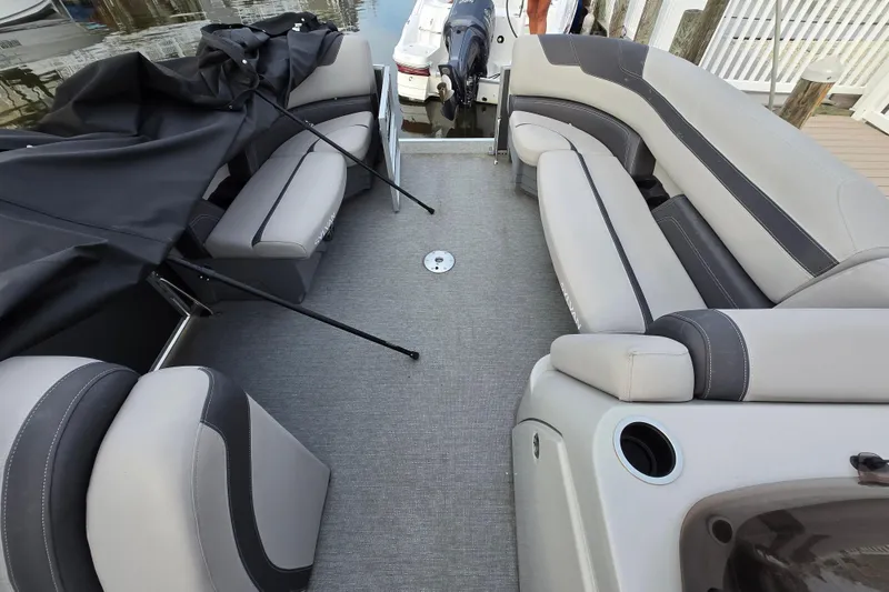 Slide: The Image of 2022 Sylvan L3 Party Fish boat interior with gray seating and covered area. - 4
