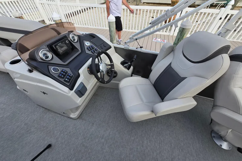 Slide: The Image of 2022 Sylvan L3 Party Fish boat interior with modern helm and comfortable seating. - 6
