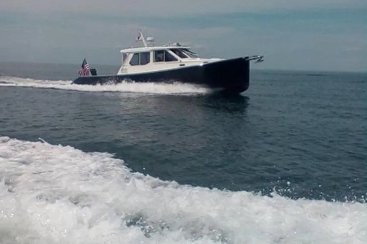 Slide: The Image of 2004 True North 38 Heritage boat cruising on open water. - 1