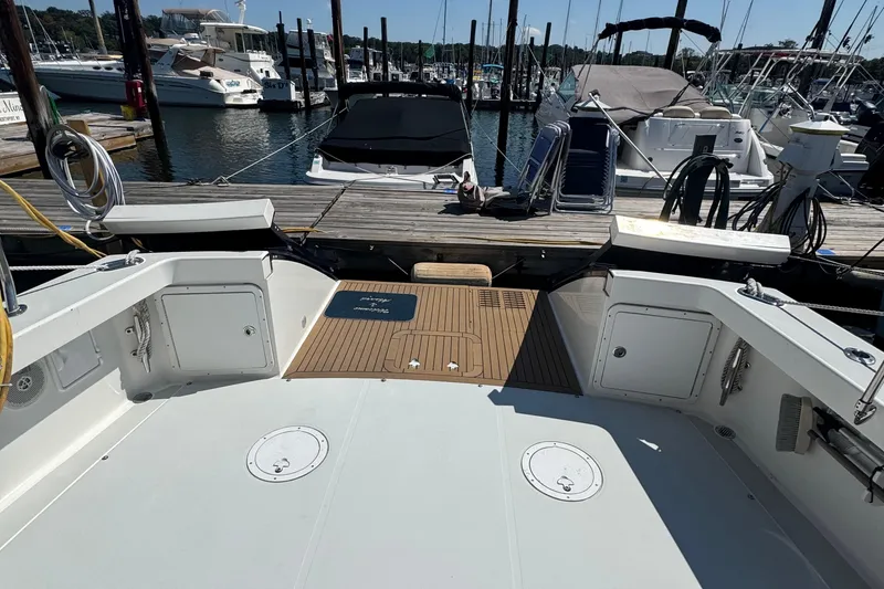 Slide: The Image of 2004 True North 38 Heritage yacht docked at marina, showcasing spacious deck area. - 11
