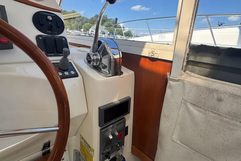 Slide: The Image of Helm of 2004 True North 38 Heritage boat with steering wheel and controls. - 19