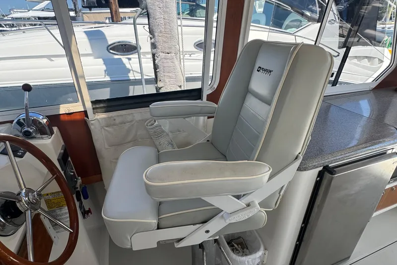 Slide: The Image of Captain's chair on 2004 True North 38 Heritage boat, near helm with steering wheel. - 22