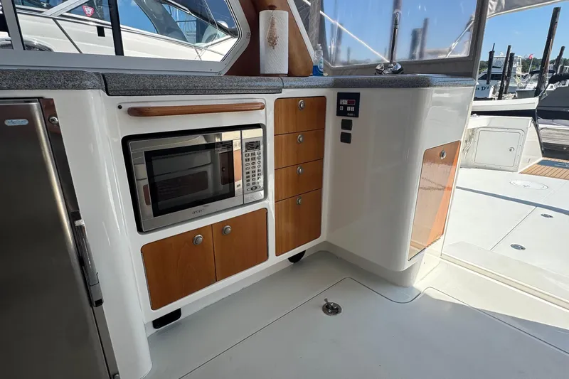 Slide: The Image of 2004 True North 38 Heritage yacht interior with microwave and wooden cabinetry. - 26