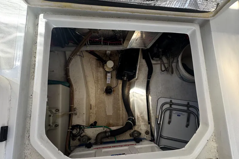 Slide: The Image of Engine compartment of 2004 True North 38 Heritage boat, showing mechanical components and wiring. - 27