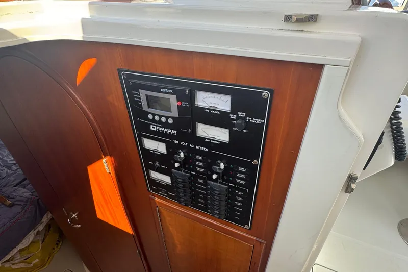 Slide: The Image of Control panel on a 2004 True North 38 Heritage boat, featuring electrical system gauges. - 34