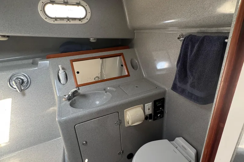 Slide: The Image of Compact bathroom in 2004 True North 38 Heritage boat with sink, toilet, and towel rack. - 39