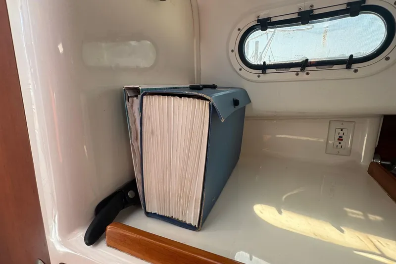 Slide: The Image of Large blue binder inside a 2004 True North 38 Heritage boat cabin. - 41