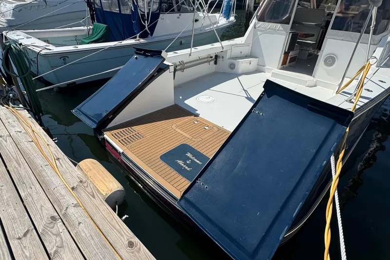 Slide: The Image of 2004 True North 38 Heritage yacht docked with open rear hatches. - 5