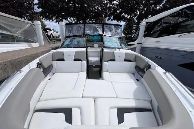 Slide: The Image of 2023 Four Winns H290 boat interior with spacious seating and modern design. - 10