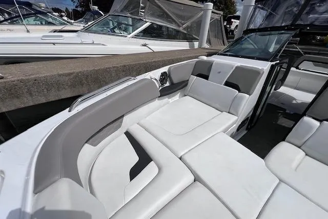 Slide: The Image of 2023 Four Winns H290 boat with spacious white seating and sleek design. - 14