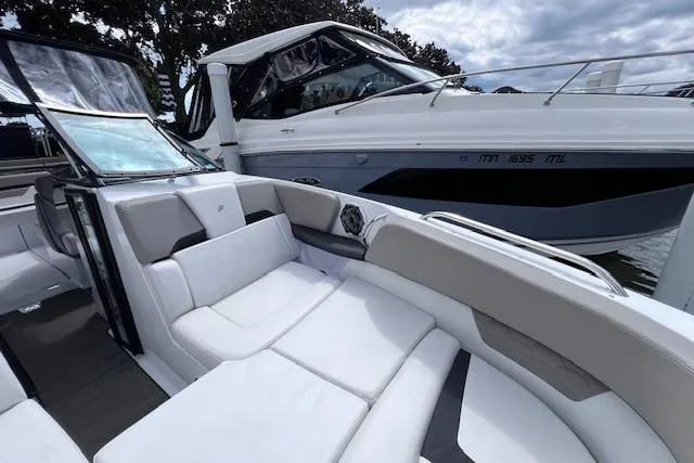 Slide: The Image of 2023 Four Winns H290 boat with luxurious seating and sleek design. - 15