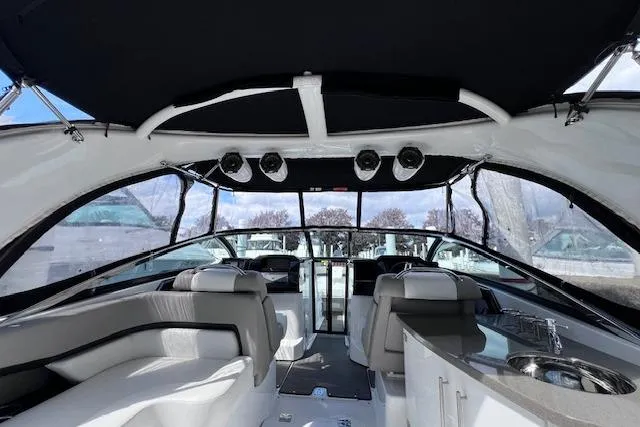 Slide: The Image of Interior of 2023 Four Winns H290 boat with sleek seating and modern amenities. - 19