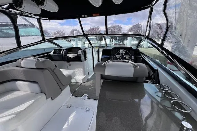 Slide: The Image of Interior of 2023 Four Winns H290 boat with modern seating and sleek dashboard design. - 22