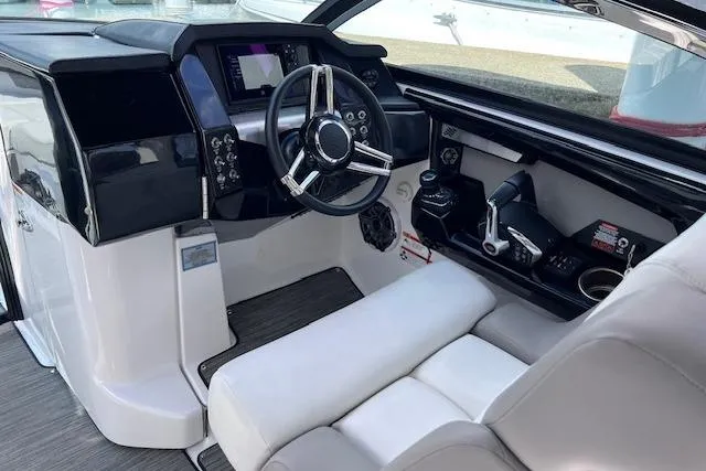 Slide: The Image of 2023 Four Winns H290 boat cockpit with modern steering and control panel. - 29