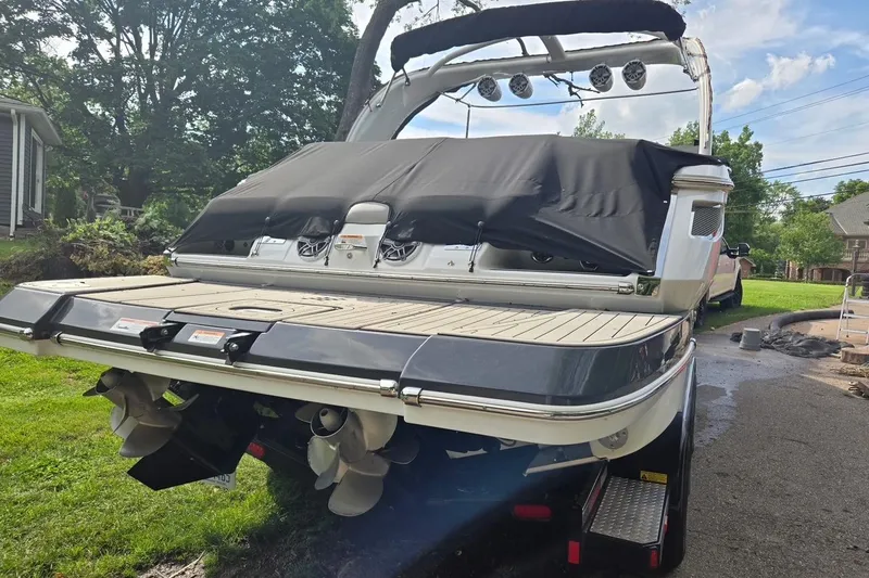 Slide: The Image of 2023 Four Winns H290 boat with covered deck and dual propellers. - 3