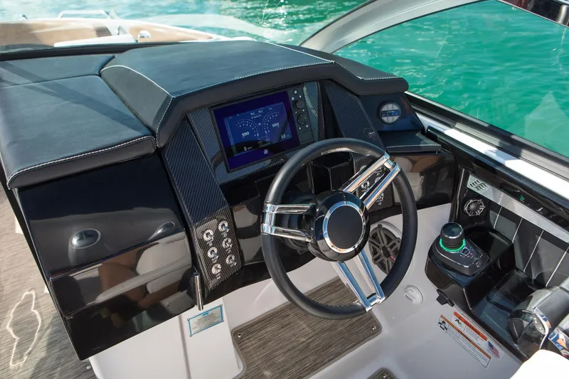 Slide: The Image of Manufacturer Provided Image: 2023 Four Winns Horizon H290 boat dashboard with steering wheel and navigation display. - 31