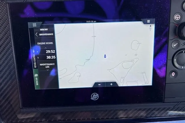 Slide: The Image of Dashboard display of a 2023 Four Winns H290 boat showing navigation and engine hours. - 35