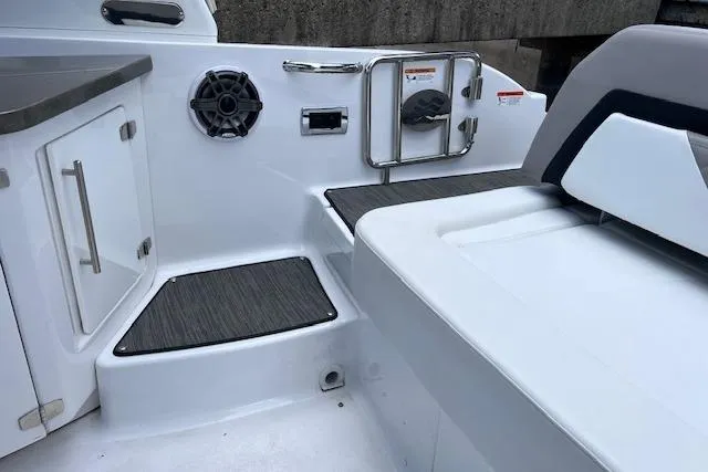 Slide: The Image of Interior view of 2023 Four Winns H290 boat, featuring seating and speaker system. - 42