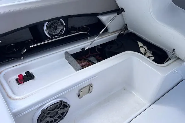 Slide: The Image of 2023 Four Winns H290 boat storage compartment with speakers and accessories. - 48