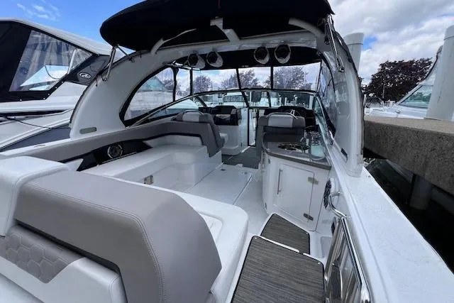 Slide: The Image of 2023 Four Winns H290 boat interior with modern seating and sleek design. - 49