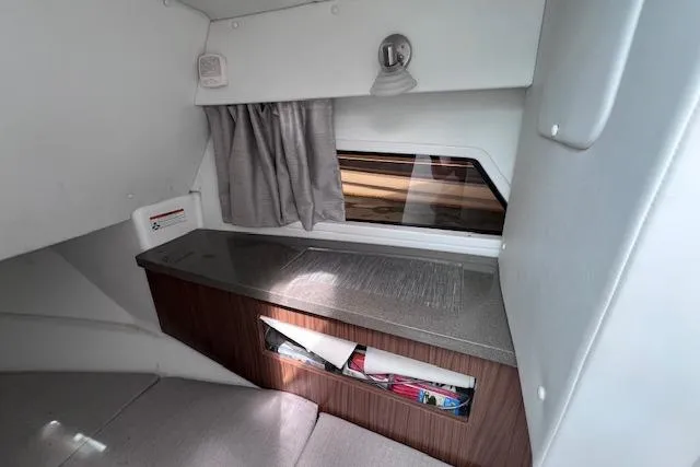 Slide: The Image of Interior cabin of 2023 Four Winns H290 boat with window and storage area. - 53