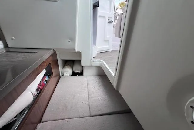 Slide: The Image of 2023 Four Winns H290 boat interior, featuring sleek design and modern amenities. - 55