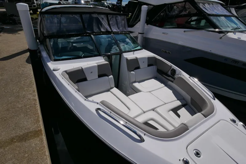 Slide: The Image of 2023 Four Winns H290 boat with sleek design and spacious seating. - 7